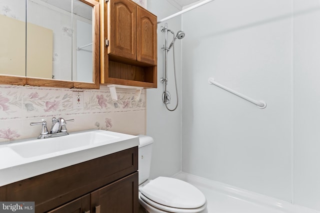 full bathroom with vanity, backsplash, a shower stall, and toilet