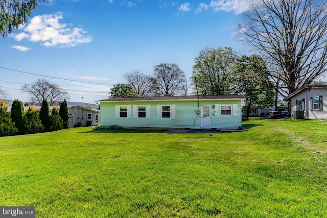 back of house with a lawn
