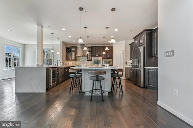 3419 Pocahontas Dr, Edgewater, MD 21037 - kitchen featuring decorative backsplash, a breakfast bar, stainless steel appliances, dark wood finished floors, and wine cooler
