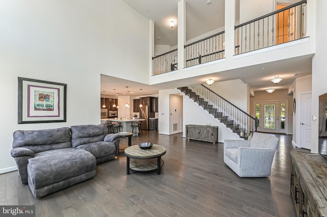 3419 Pocahontas Dr, Edgewater, MD 21037 - living area with stairway, a towering ceiling, dark wood-type flooring, and visible vents