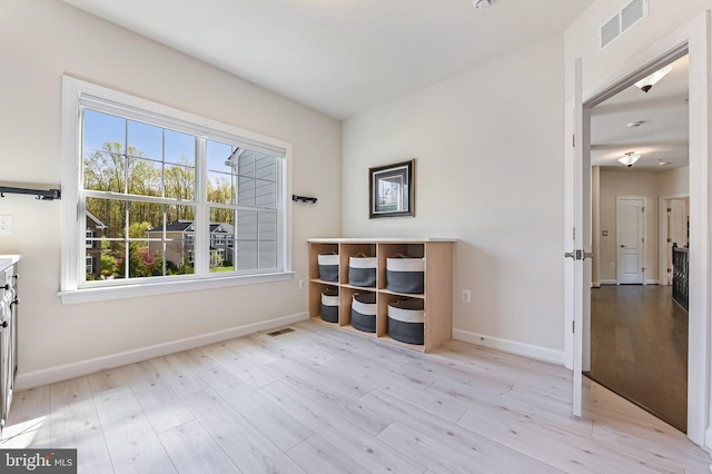 3419 Pocahontas Dr, Edgewater, MD 21037 - empty room featuring light wood finished floors, visible vents, and a wealth of natural light