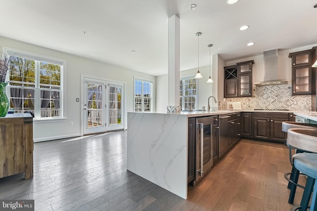 3419 Pocahontas Dr, Edgewater, MD 21037 - kitchen featuring dark wood finished floors, wall chimney exhaust hood, beverage cooler, and a wealth of natural light