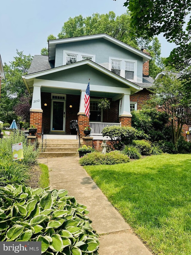 3213 Jocelyn St NW, Washington, DC 20015 - view of front facade featuring brick siding, covered porch, and a front yard