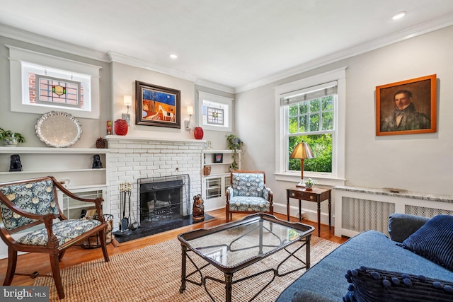 3213 Jocelyn St NW, Washington, DC 20015 - living room featuring radiator heating unit, ornamental molding, wood finished floors, a brick fireplace, and recessed lighting