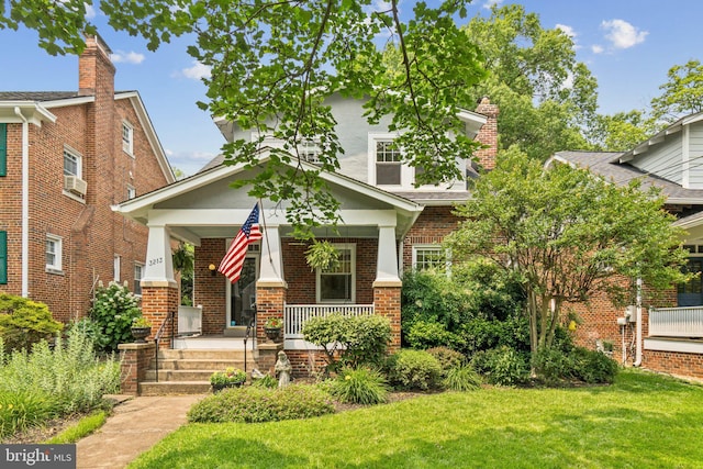 3213 Jocelyn St NW, Washington, DC 20015 - view of front of home featuring a porch, brick siding, and a front lawn