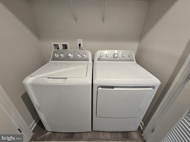laundry room featuring laundry area, washer and clothes dryer, dark wood finished floors, and baseboards