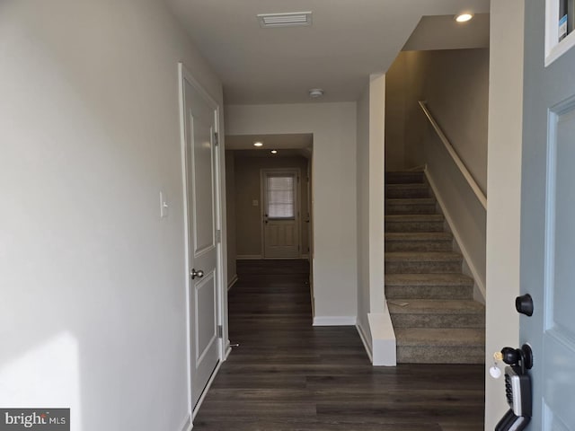 staircase with visible vents, recessed lighting, baseboards, and wood finished floors