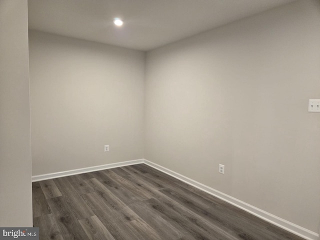 empty room with recessed lighting, baseboards, and dark wood finished floors