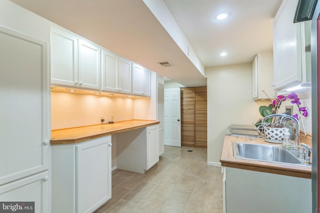 705 Hope Ln, Gaithersburg, MD 20878 - kitchen with built in desk, a sink, white cabinetry, recessed lighting, and visible vents