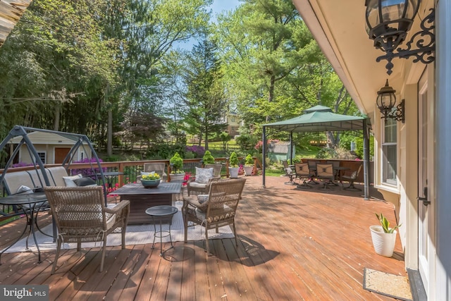 705 Hope Ln, Gaithersburg, MD 20878 - deck featuring a gazebo, outdoor dining space, and an outdoor hangout area
