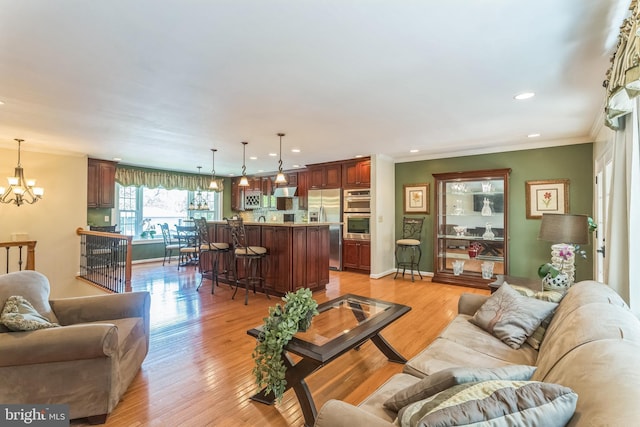 705 Hope Ln, Gaithersburg, MD 20878 - living room featuring an inviting chandelier, recessed lighting, light wood-style flooring, and crown molding