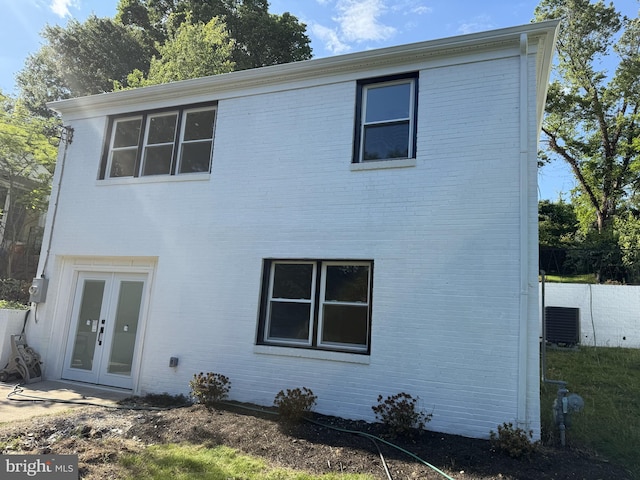 402 Elm Ave, Takoma Park, MD 20912 - view of front of home featuring brick siding, central AC, and french doors