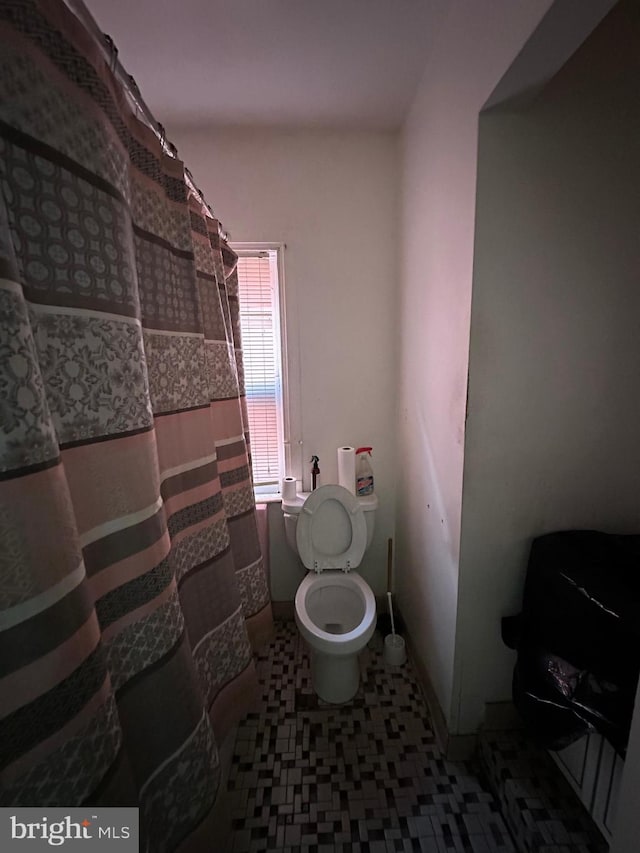 bathroom with tile patterned floors and toilet