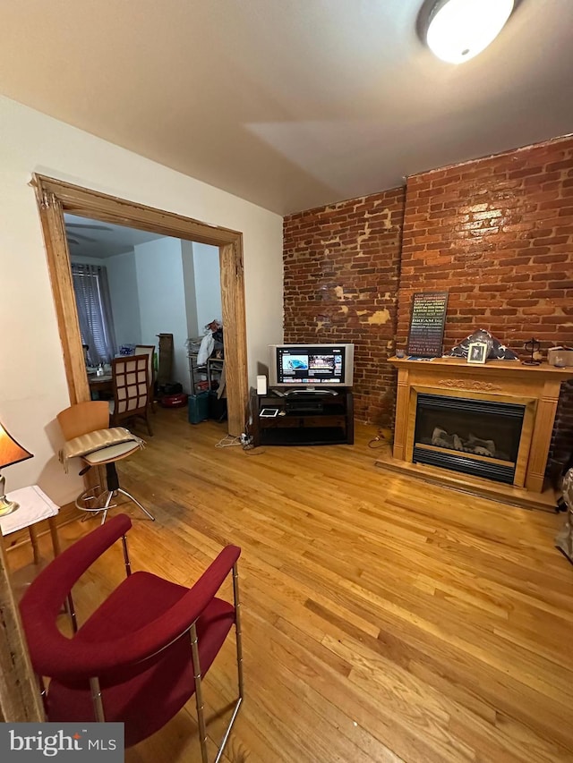 living area featuring a glass covered fireplace and light wood-type flooring