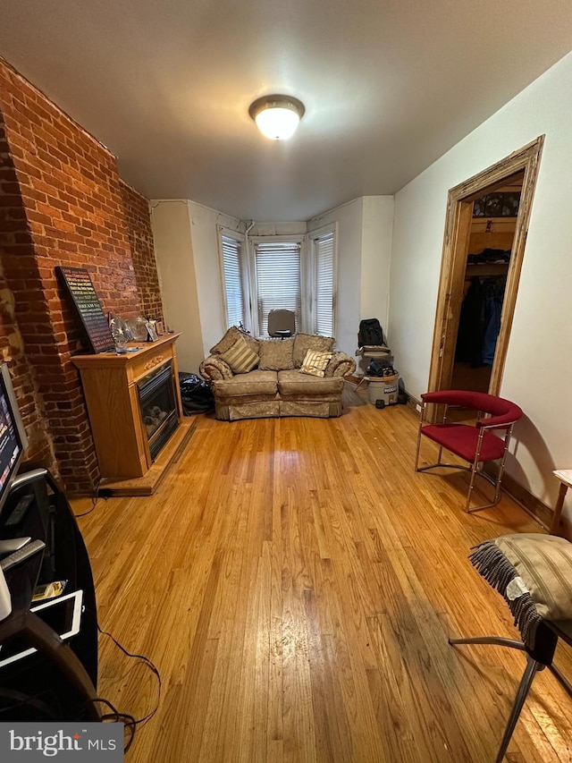 living room with light wood finished floors and a fireplace