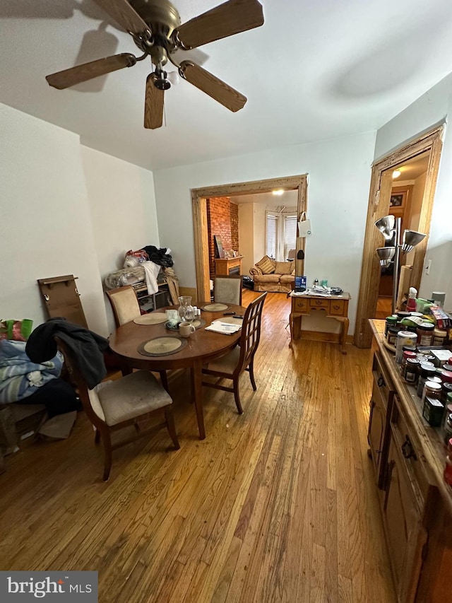 dining area featuring a ceiling fan and light wood-style flooring
