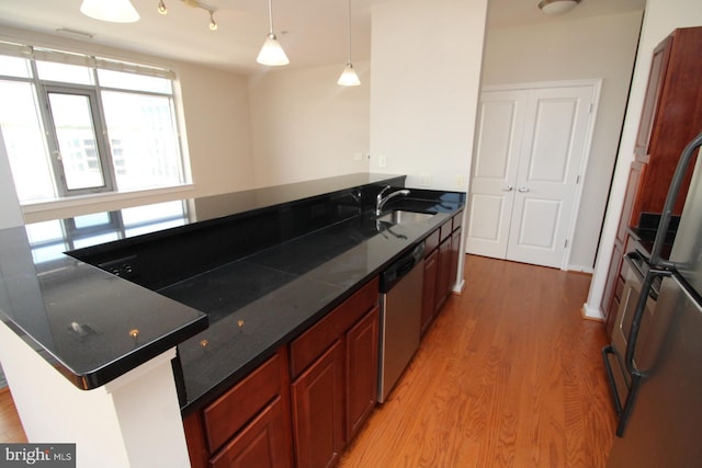 6506 America Blvd Unit 302, Hyattsville, MD 20782 - kitchen with stainless steel dishwasher, a sink, pendant lighting, light wood finished floors, and a peninsula