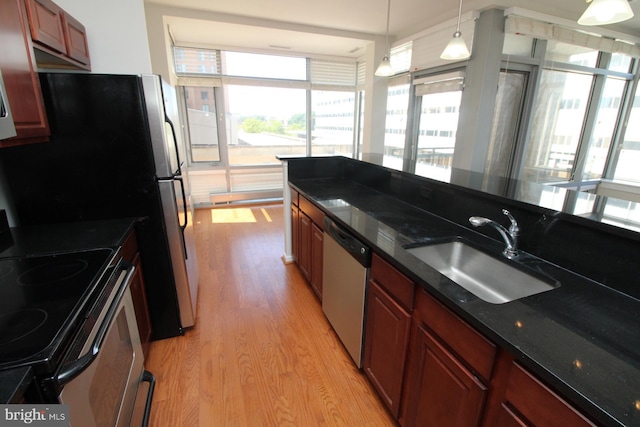 6506 America Blvd Unit 302, Hyattsville, MD 20782 - kitchen with stainless steel dishwasher, light wood-style flooring, a sink, electric range, and hanging light fixtures