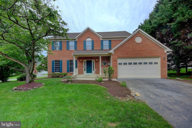 13434 Fairland Park Dr, Silver Spring, MD 20904 - view of front of home featuring asphalt driveway, a front yard, a garage, and brick siding
