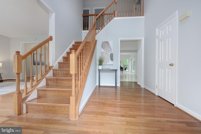 13434 Fairland Park Dr, Silver Spring, MD 20904 - stairs featuring wood finished floors, baseboards, and a high ceiling