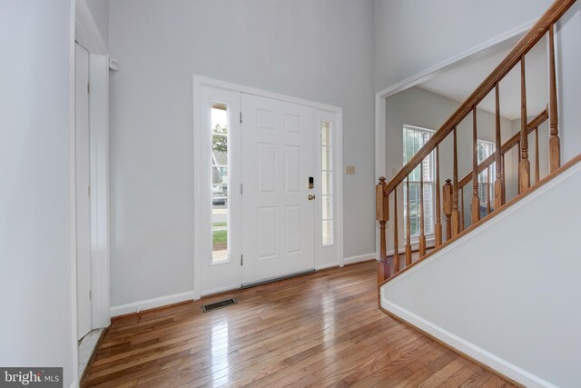 13434 Fairland Park Dr, Silver Spring, MD 20904 - foyer with plenty of natural light, wood-type flooring, a high ceiling, and stairway