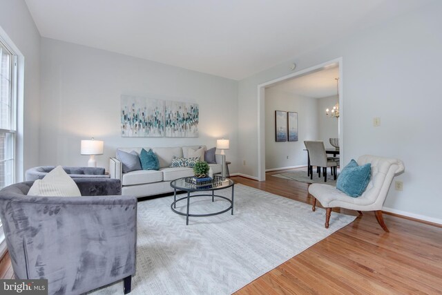 13434 Fairland Park Dr, Silver Spring, MD 20904 - living room featuring wood finished floors, a chandelier, and baseboards