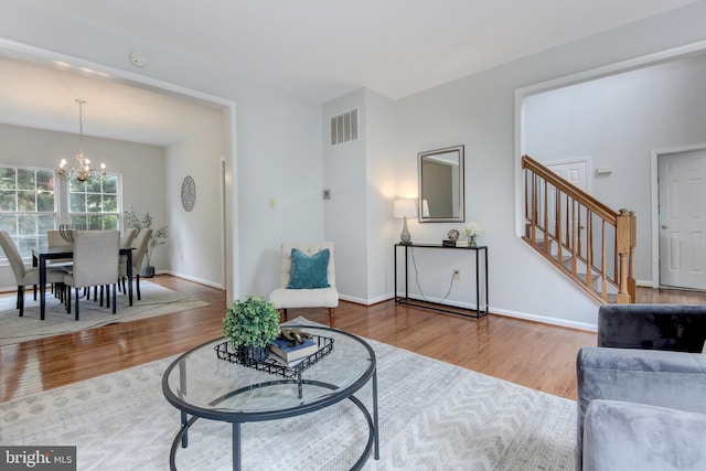 13434 Fairland Park Dr, Silver Spring, MD 20904 - living area with wood finished floors, stairway, a chandelier, and baseboards