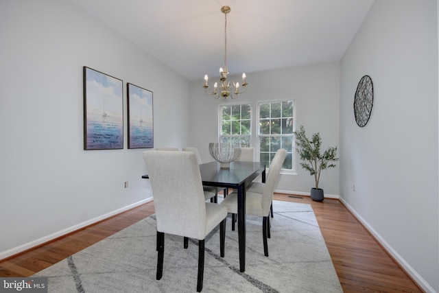 13434 Fairland Park Dr, Silver Spring, MD 20904 - dining space with a chandelier, wood finished floors, and baseboards