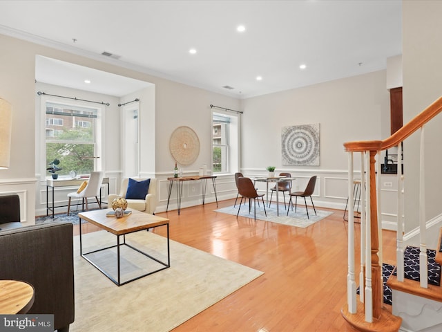 living room featuring crown molding, light wood-style flooring, stairway, visible vents, and recessed lighting
