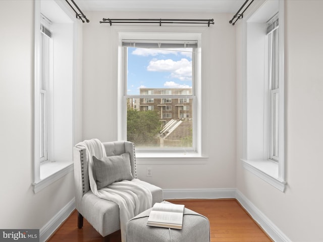 living area featuring wood finished floors and baseboards
