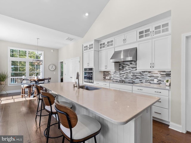 32953 Shadeland Ave, Millsboro, DE 19966 - kitchen with a sink, stainless steel oven, wall chimney exhaust hood, backsplash, and a center island with sink