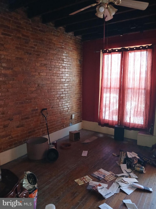109 N Payson St N, Baltimore, MD 21223 - spare room with ceiling fan, a healthy amount of sunlight, hardwood / wood-style flooring, and brick wall