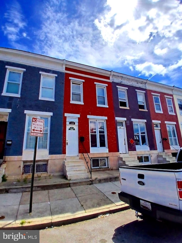 109 N Payson St N, Baltimore, MD 21223 - townhome / multi-family property with brick siding and entry steps