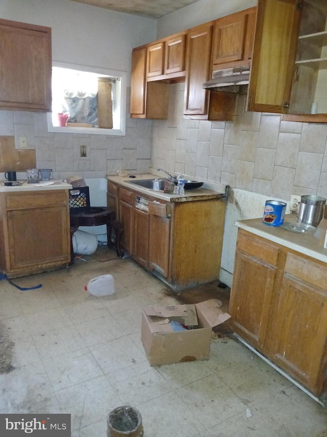 109 N Payson St N, Baltimore, MD 21223 - kitchen with decorative backsplash, light floors, and brown cabinets