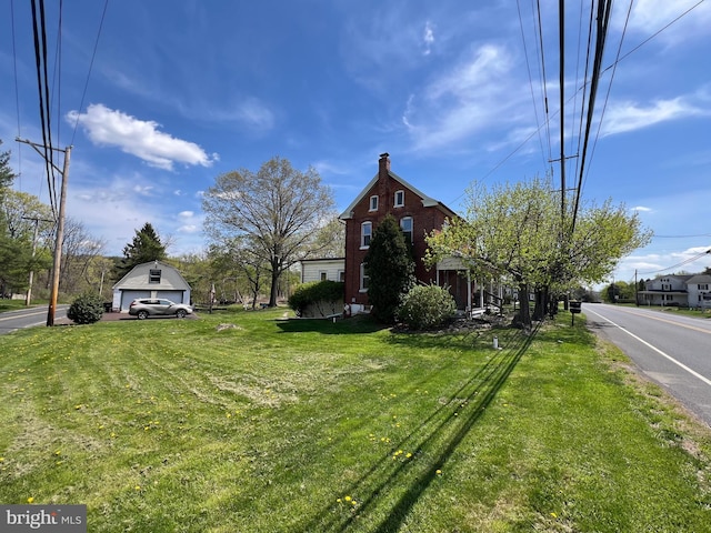 exterior space featuring a chimney and a front lawn