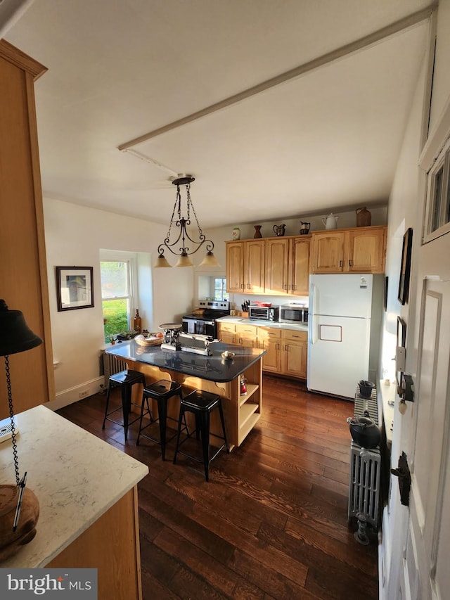 kitchen with freestanding refrigerator, open shelves, a center island, dark wood-type flooring, and stainless steel microwave
