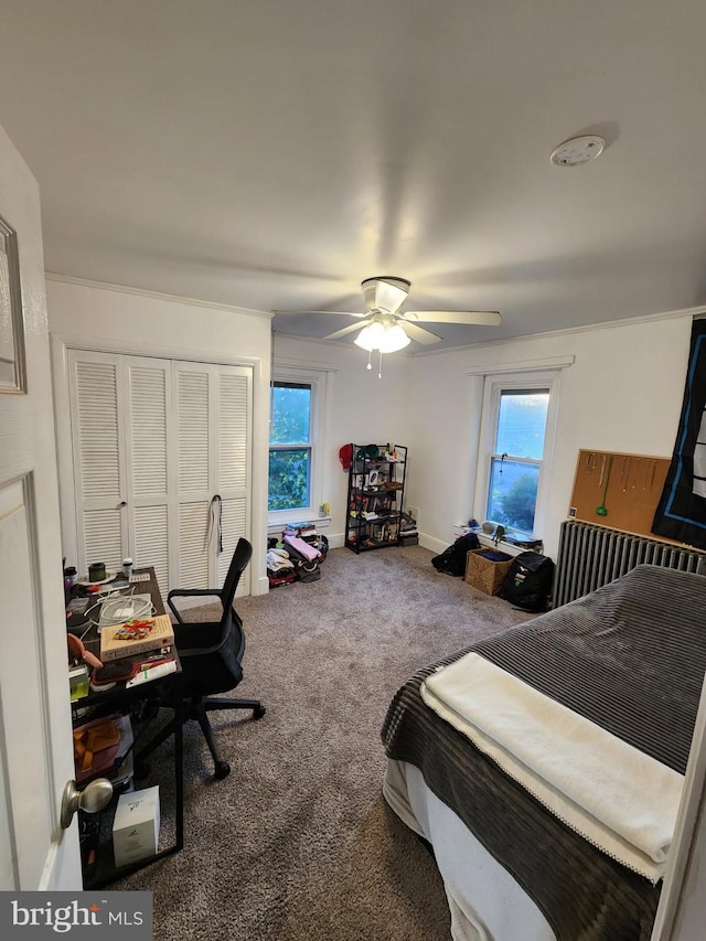 carpeted bedroom featuring a ceiling fan and a closet
