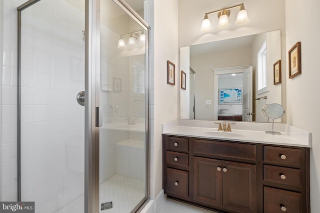 ensuite bathroom featuring vanity, connected bathroom, and a stall shower