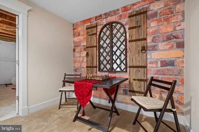 dining area featuring carpet flooring and baseboards