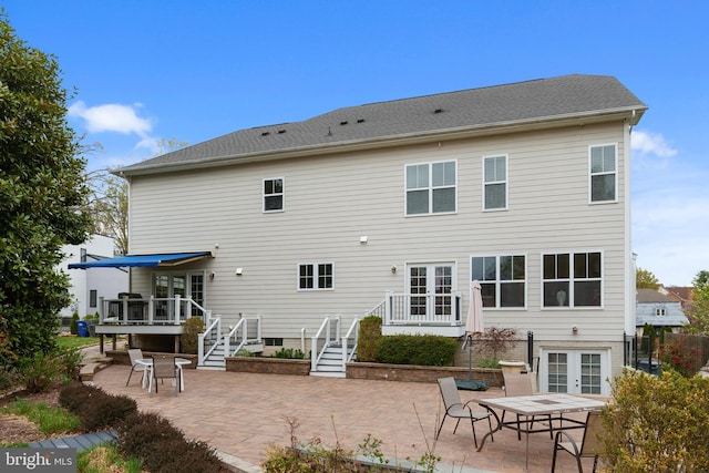 rear view of property with french doors, a patio area, stairs, and a deck