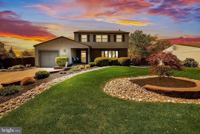 traditional-style home with a garage, driveway, and a front lawn