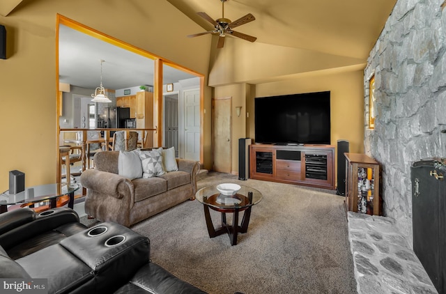 carpeted living room featuring vaulted ceiling and a ceiling fan