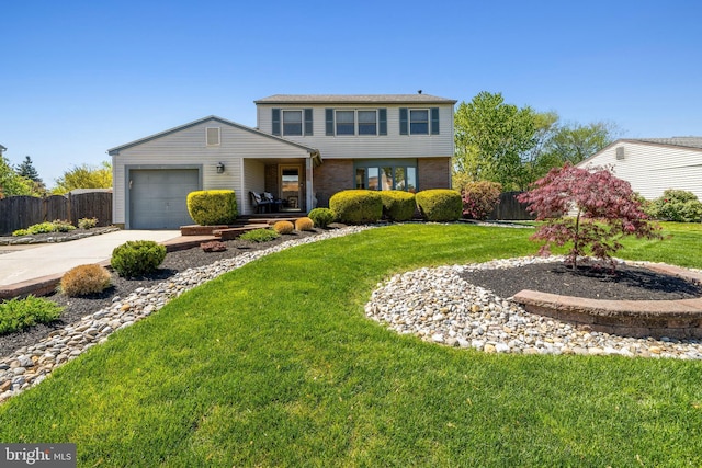 view of front facade with a garage, fence, a front yard, brick siding, and driveway