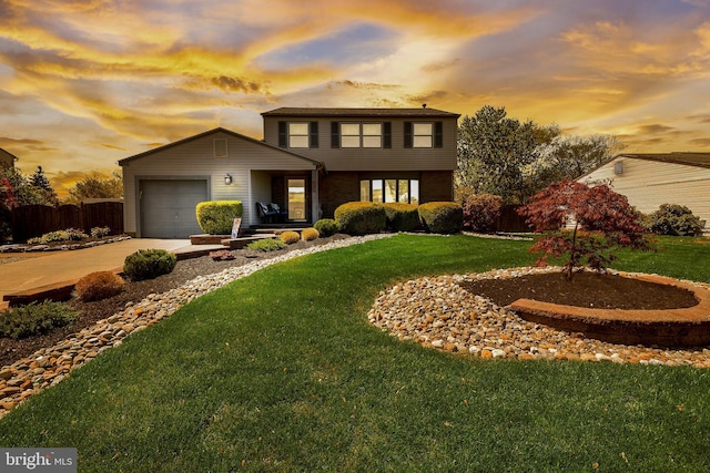 traditional-style home with an attached garage, concrete driveway, and a front lawn