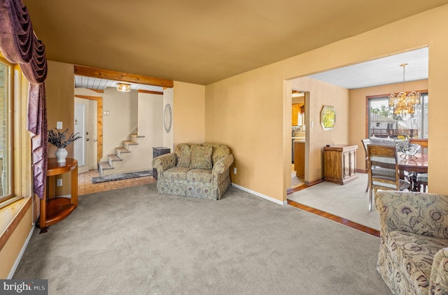 living area featuring carpet flooring, baseboards, an inviting chandelier, and stairway