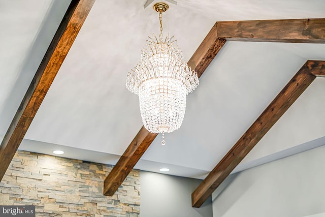 room details featuring beamed ceiling, recessed lighting, and an inviting chandelier