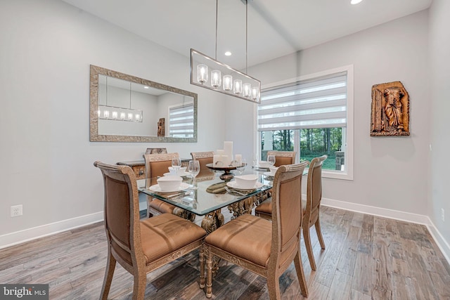 dining room featuring baseboards, recessed lighting, and wood finished floors