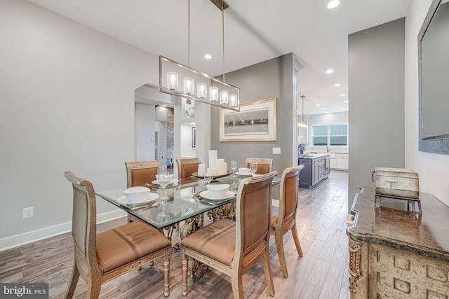 dining space featuring recessed lighting, wood finished floors, and baseboards