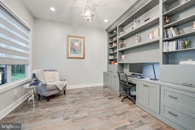 office space featuring light wood finished floors, recessed lighting, a chandelier, and baseboards