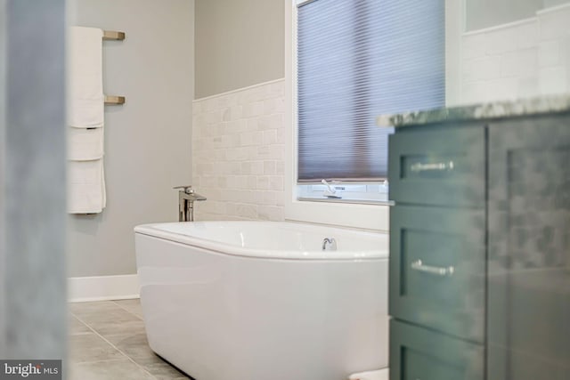 full bathroom featuring a bath and baseboards